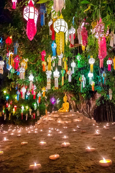 Statue decorated with candles and lamps — Stock Fotó