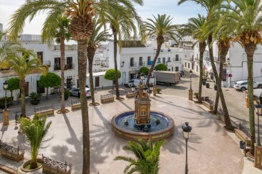 Beautiful fountain on Plaza de Espana square in picturesque Vejer de la Frontera town in Andalusia, Spain. Pueblos blancos or white towns in Andalusia.