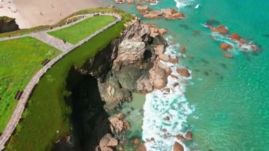 İspanya 'nın Galiçya kentindeki Cantabrian Denizi kıyısının hava manzarası. Yeşil çayırlar, yüksek uçurumlar, beyaz kumsallar ve turkuaz sular. Atlantik kıyısında manzaralı bir kıyı yolu var..