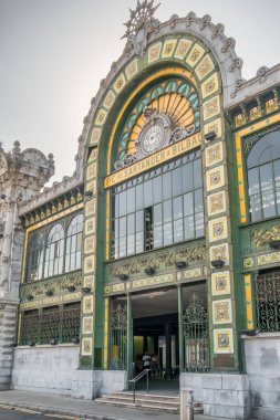 Bilbao, İspanya - 10 Ağustos 2024: Santander İstasyonu olarak bilinen tarihi La Concordia istasyonunun dış görünüşü, Belle Epoque mimarisi, büyük bir saat ve süslü yeşil demir işlerinin yer aldığı.