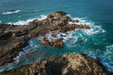 Sea water crashing into rocks on Java