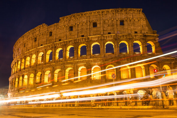 Colosseum at night with traffic lights