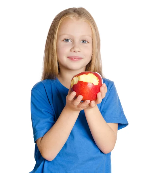 Beautiful girl at table shows the bitten Apple on white backgrou — Stock Photo, Image