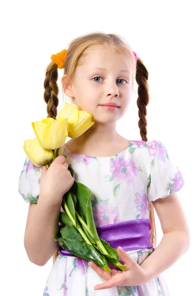 Little girl holding yellow tulips isolated on white — Stock Photo, Image