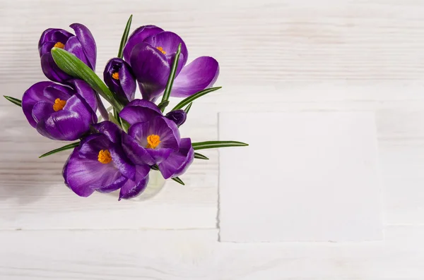 Buquê de flores de croco em vaso na mesa de madeira branca com — Fotografia de Stock