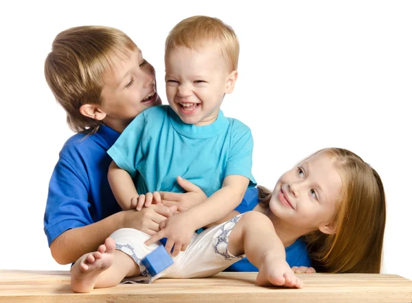 Cute boy and a girl playing with the kid on white background — Stock Photo, Image