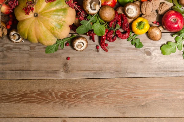 Vegetables, nuts, berries and  fruits over old wooden table. — Stock Photo, Image