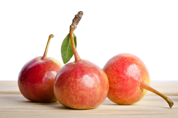 Three small pears  in a grouping on wooden table — Stock Photo, Image