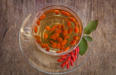 Goji taze antioksidan çay barberries içinde ahşap ve cam Kupası
