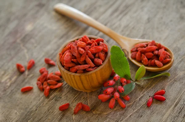 Berberries and goji berries on wooden background — Stock Photo, Image
