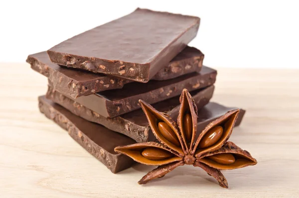 Star of anise  and chocolate  on wooden table — Stock Photo, Image