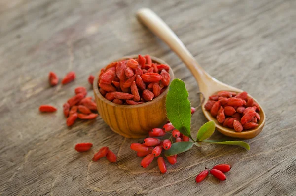 Barberries and goji berries on wooden background — Stock Photo, Image