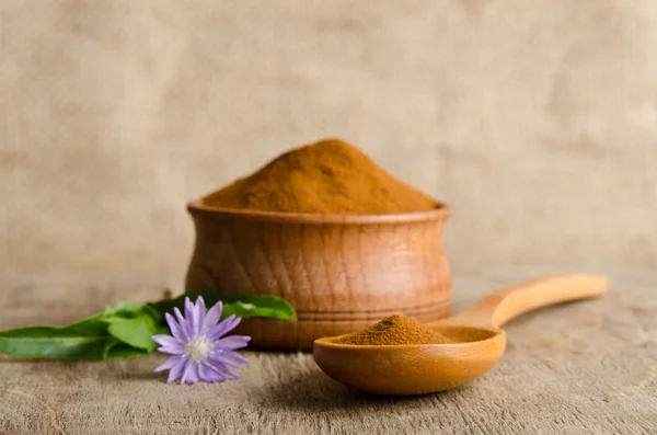 Blue chicory flower and full wooden spoon of powder  instant chi — Stock Photo, Image