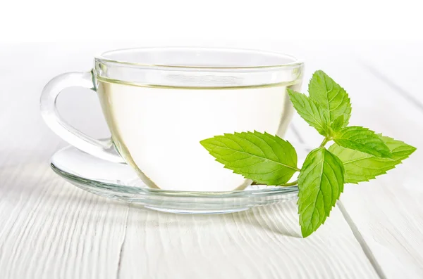 Glas kopje thee met munt op de witte houten tafel — Stockfoto