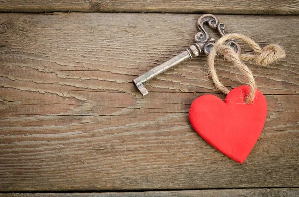 Corazón hecho a mano con llave juntos acostados en un tablero de madera.top vi —  Fotos de Stock