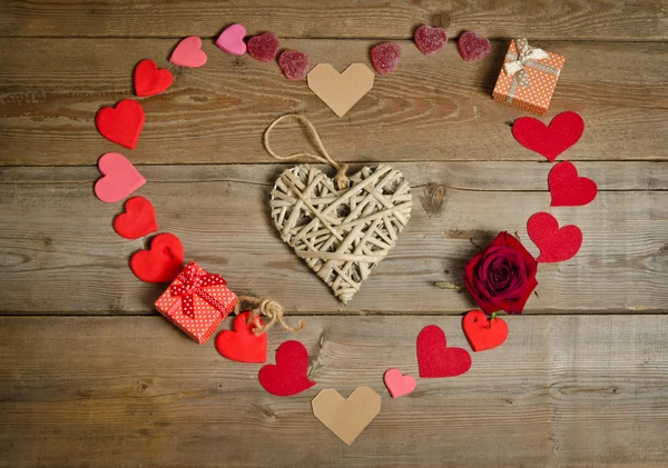 The handmade wicker heart in the centre and around many hearts — Stock Photo, Image