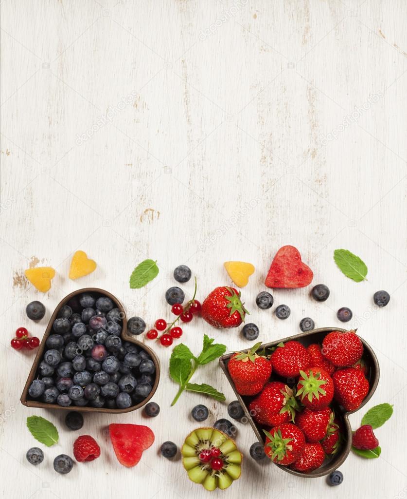 Fruits and berries on white marble background