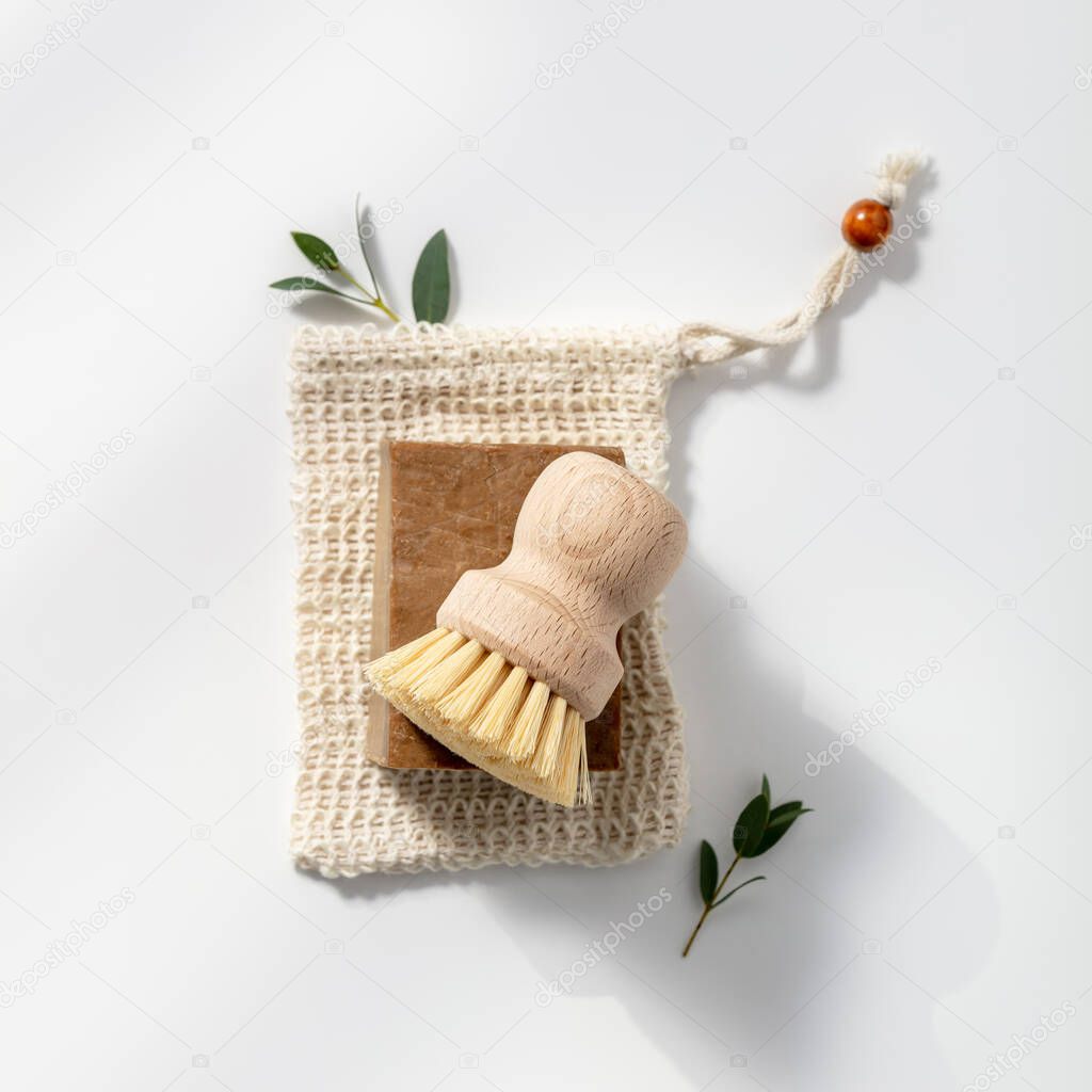 Eco friendly natural cleaning tools and products, Solid soap and natural dish brush on white background.