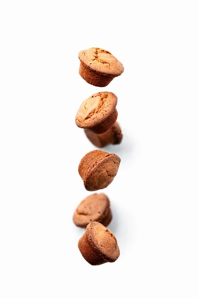 Chocolate muffins falling or flying in motion — Stock Photo, Image