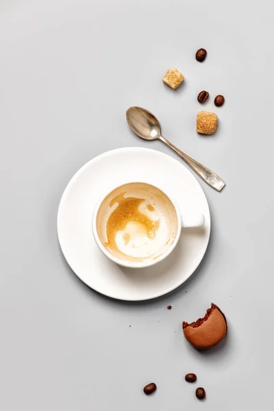 Порожня чашка кави і шматочок шоколадного макаруни — стокове фото