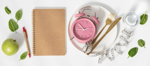 Composition with cutlery, measuring tape, blank paper notebook and alarm clock on color background. Diet concept, copy space — Stock Photo, Image