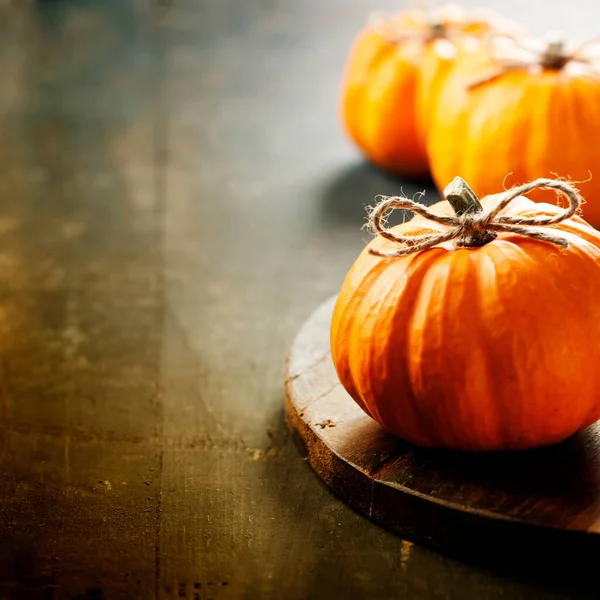 Autumn pumpkins on wooden table, close up. Harvest, Thanksgiving concept — Stock Photo, Image