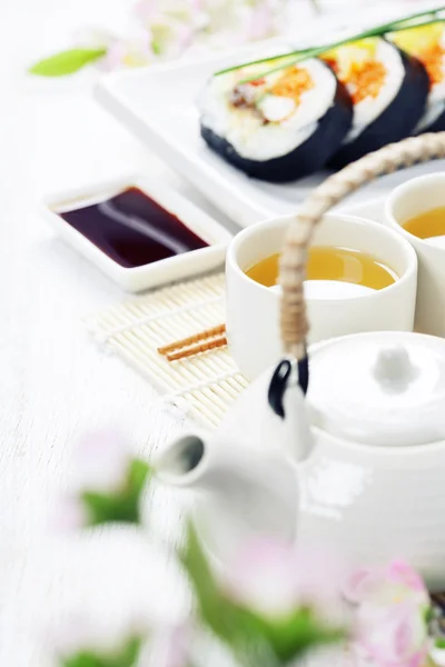 Sushi set, green tea and sakura branch — Stock Photo, Image