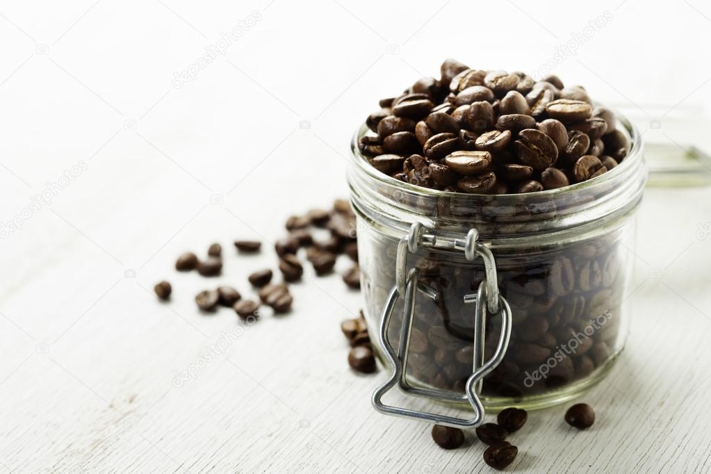 Large glass jar full of coffee beans