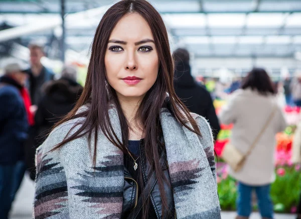 Attractive young woman with long beautiful hairs posing in flower greenhouse of Keukenhof park. — Stock Photo, Image