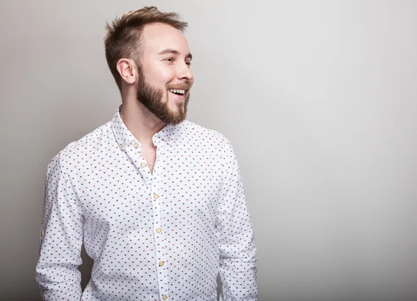 Portrait of young handsome positive man in white shirt with an amusing pattern. — Stock Photo, Image