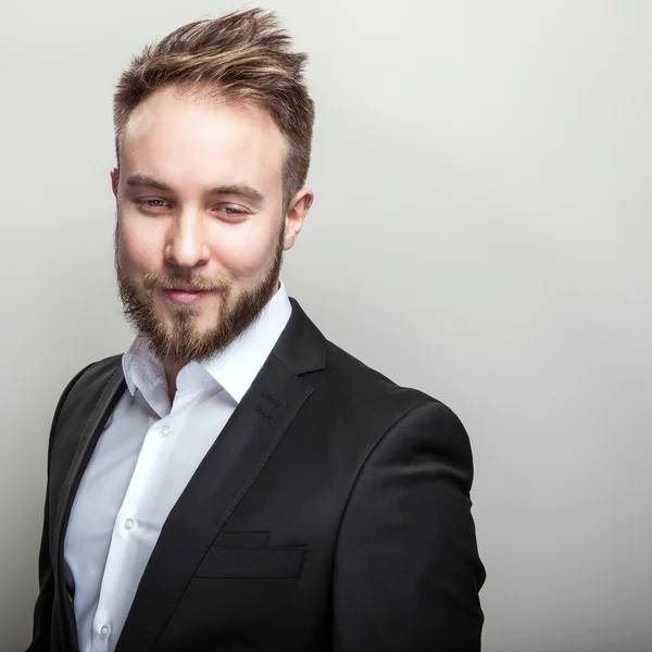 Elegant young handsome bearded man in classic black costume & white shirt. — Stock Photo, Image