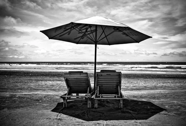Plank beds under a beach umbrella. Black-white photo. — Stock Photo, Image