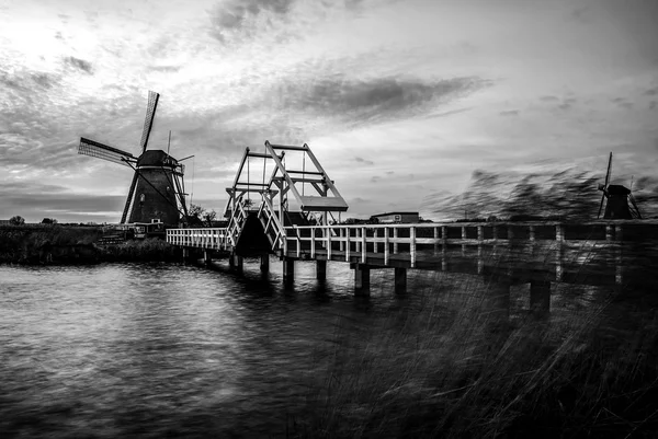 House inside windmill building on sunset in Kinderdijk, Holland. Black-white photo. — Stock Photo, Image