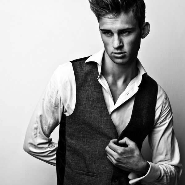 Elegant stylish handsome man. Black-white studio fashion portrait. 