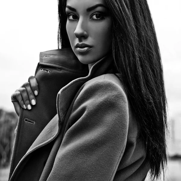 Black-white portrait of a beautiful fashionable woman on coat outdoor. — Stock Photo, Image