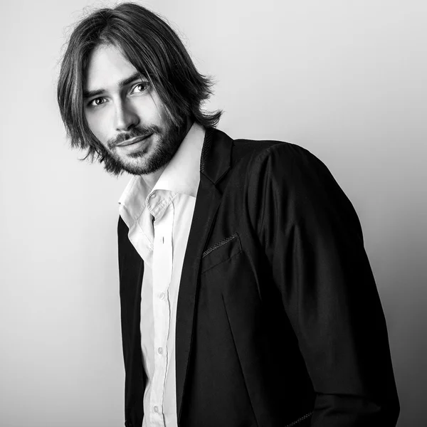 Elegant young long hair handsome man pose in studio — Stock Photo, Image