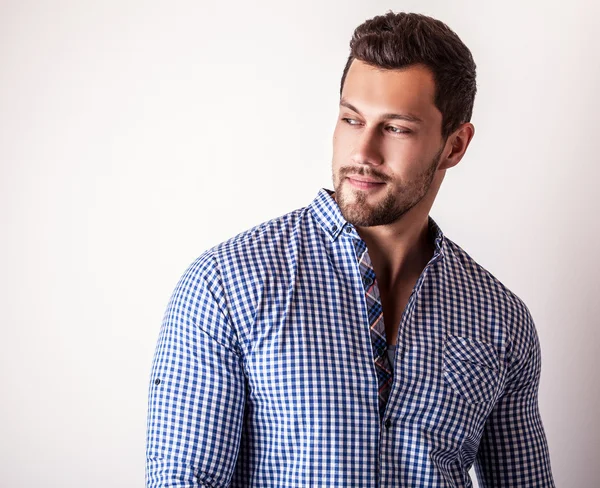 Elegante joven hombre guapo en camisa azul con estilo. Estudio retrato de moda — Foto de Stock