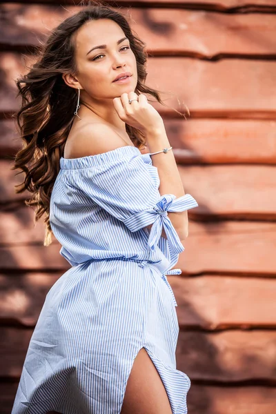 Young sensual & beauty girl in blue dress pose against grunge wooden background — Stock Photo, Image