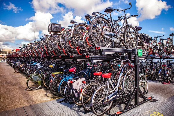 AMSTERDAM, NETHERLANDS - AUGUST 15, 2016: Two-level parking of bicycles in Amsterdam city. Amsterdam - Netherlands.