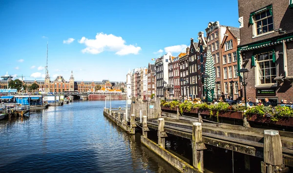 AMSTERDAM, NETHERLANDS - AUGUST 15, 2016: Famous buildings of Amsterdam city centre close-up. General landscape view of city streets and traditional Dutch architecture. Amsterdam - Netherlands.