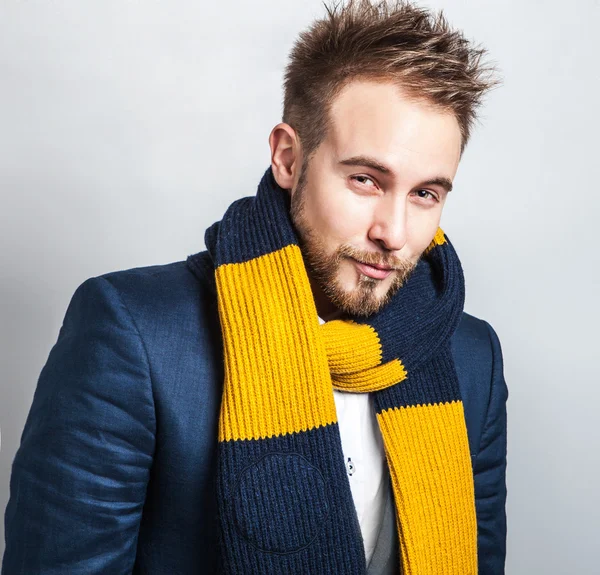 Elegant & Positive young handsome man in colorful scarf. Studio fashion portrait.