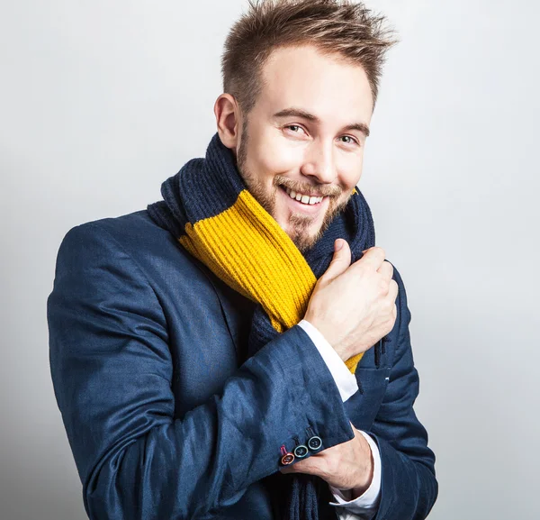 Elegante y positivo joven guapo hombre en bufanda de colores. Estudio retrato de moda . —  Fotos de Stock