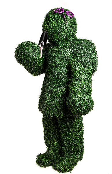 Ragazza cespuglio posa con una piccola pala da giardino isolato su uno sfondo bianco. Studio foto . — Foto Stock