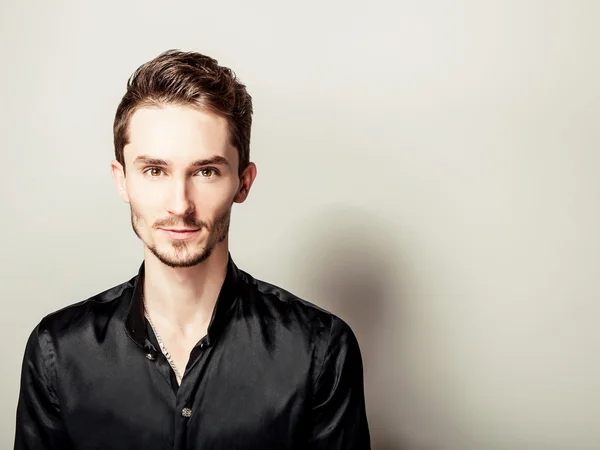 Elegant young handsome man in black silk shirt. Studio fashion portrait. — Stock Photo, Image