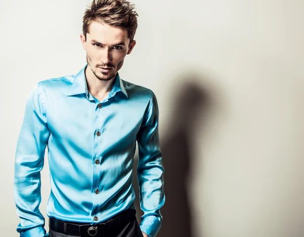 Elegant young handsome man in blue silk shirt. Studio fashion portrait. — Stock Photo, Image