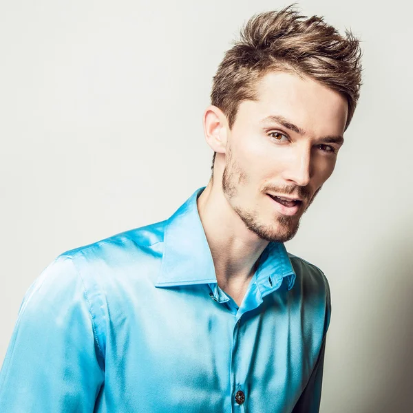 Elegant young handsome man in blue silk shirt. Studio fashion portrait. — Stock Photo, Image