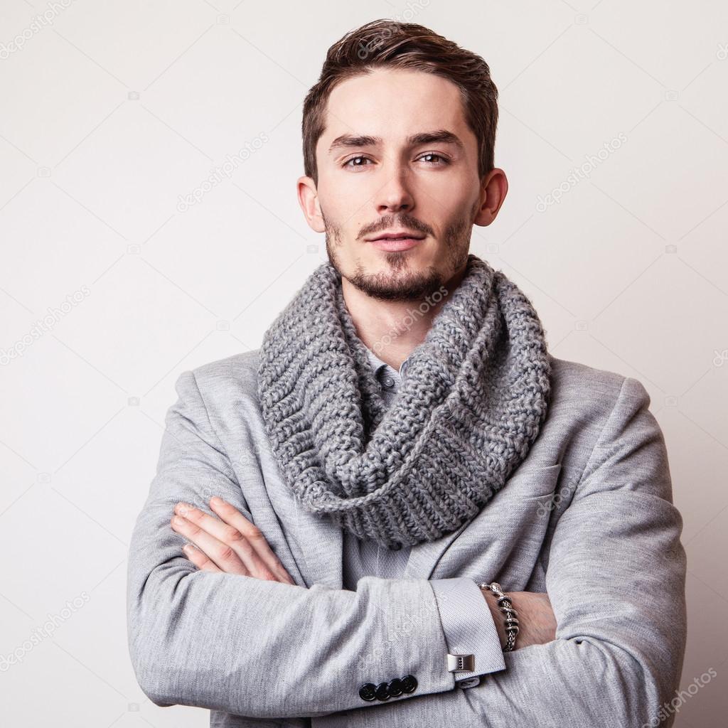 Elegant young handsome man in grey costume. Studio fashion portrait.