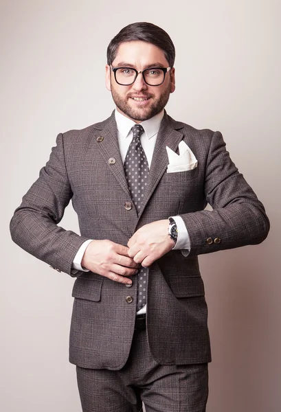 Elegante jovem e bonito homem de fato cinzento. Estúdio retrato de moda . — Fotografia de Stock