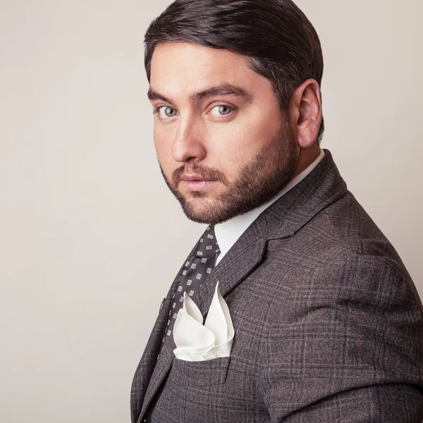 Elegante joven guapo en traje gris. Estudio retrato de moda . —  Fotos de Stock