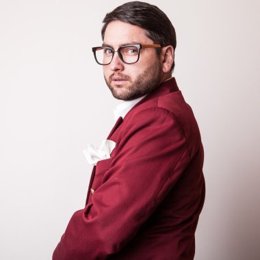 Lüks Kırmızı kostümlü zarif genç yakışıklı adam. Studio moda portre.